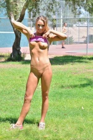 Fit blonde jogger in short shorts revealing wide open twat in public park on leakfanatic.com