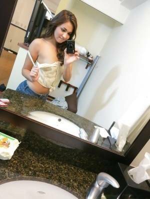 Sassy brunette stripping in front of the mirror and making selfies on leakfanatic.com