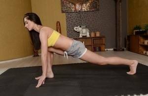 Cute brunette babe Aruna Aghora doing yoga in shorts and bare feet on leakfanatic.com
