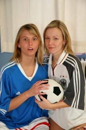 Cute teen girls go lesbian after trying on soccer outfits on a bed on leakfanatic.com