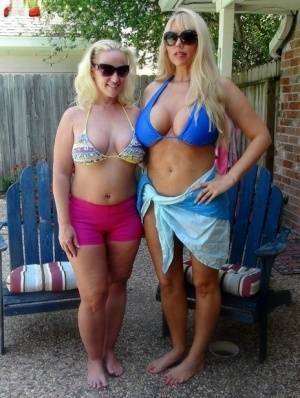 Blonde chicks Karen Fisher and Dee Siren loose their big tits from bikini tops on leakfanatic.com