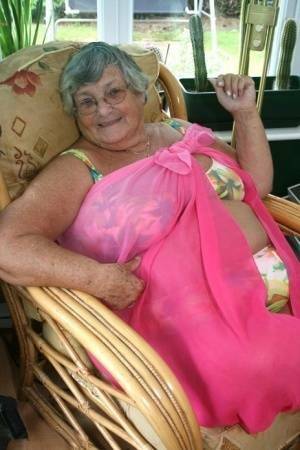 Horny old granny in glasses disrobes to reveal huge saggy tits & big BBW ass on leakfanatic.com