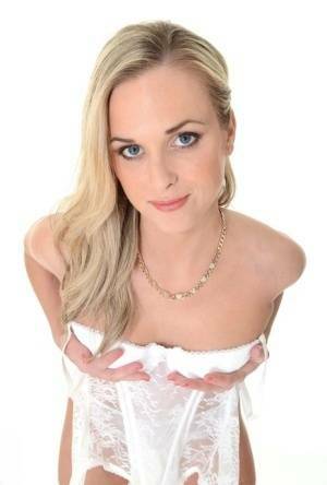 Pretty blonde Vinna Reed takes off white lingerie and matching hosiery on leakfanatic.com