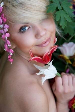 Cute young blonde Iveta poses in the nude while in a garden on leakfanatic.com