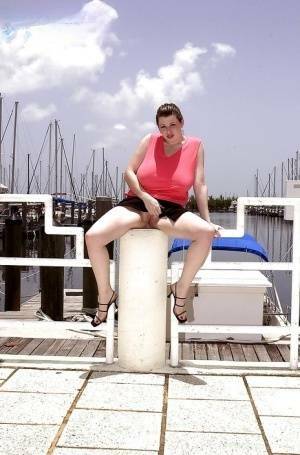 Plump pornstar Desirae flashing her huge tits and upskirt pussy on boat dock on leakfanatic.com