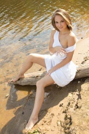 White teen of legal age shows off her naked body on a log that's beached on leakfanatic.com