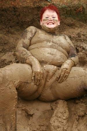 Older redhead Valgasmic Exposed rolls around in a mud pit while totally naked on leakfanatic.com