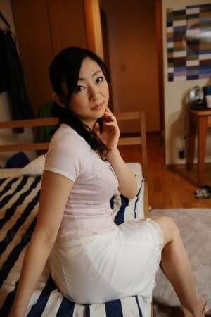 Slender mature Japanese woman Emiko Koike bends over to pose in white dress - Japan on leakfanatic.com