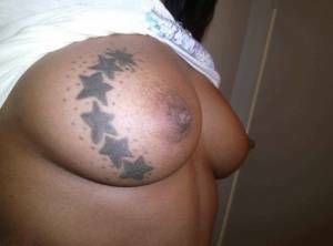 Ebony amateur takes self shots of her big tattooed boobs and bald vagina on leakfanatic.com