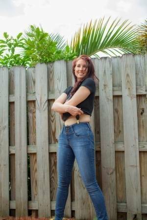 Hot redhead Andy Adams loses her t-shirt & jeans in the yard to pose naked on leakfanatic.com