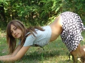 Shapely young teen in tiny t-shirt and short skirt posing outdoors on leakfanatic.com