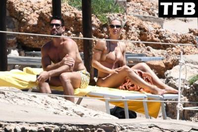 Michelle Hunziker & Giovanni Angiolini Relax on the Beach of Their Hotel in Sardinia on leakfanatic.com