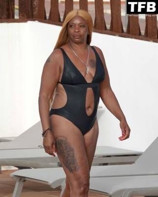 Sandi Bogle Shows Off Her Voluptuous Figure in a Swimsuit Poolside Out in Ibiza on leakfanatic.com