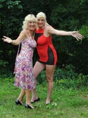 Mature lesbian Dimonty and GF cover their naked bodies in see thru raincoats on leakfanatic.com