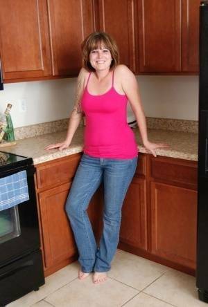 Redhead amateur Misty B gets completely naked in her kitchen on leakfanatic.com