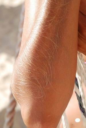 Amateur model Lori Anderson shows her hairy arms in a bikini and sunglasses on leakfanatic.com