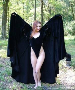 Redhead amateur Amber Lily models nude in a forest draped in a black cape on leakfanatic.com