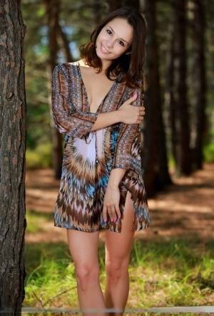 Sweet teen with an ass to die for disrobes for great nude poses in a forest on leakfanatic.com