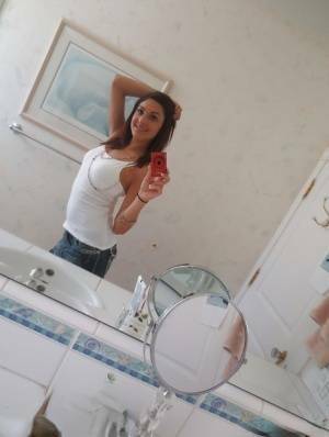 Nasty brunette slut Nikka taking couple of selfies in the bathroom on leakfanatic.com