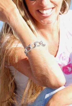 Amateur model Lori Anderson shows off her hairy arms while fully clothed on leakfanatic.com