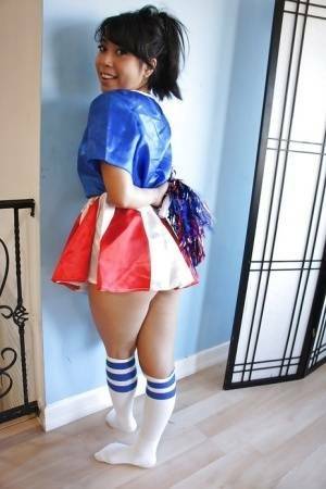 Tiny Asian cheerleader May Lee posing in cute uniform and socks on leakfanatic.com