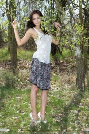 Long legged Michaela Isizzu flashes naked upskirt and poses nude in the forest on leakfanatic.com