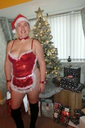Busty blonde Barby masturbates her shaved pussy near the Christmas tree on leakfanatic.com