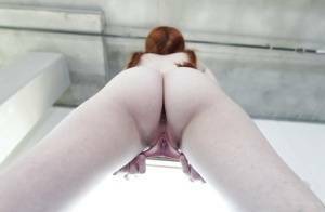 Young redhead Dolly Little revealing shaved pussy in pigtails and socks on leakfanatic.com