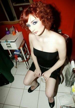 Pale redhead Violet Monroe gets naked in flat shoes while in a bathroom on leakfanatic.com