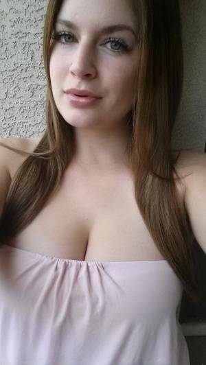 Plump amateur Danielle takes topless and clothed selfies around the house on leakfanatic.com