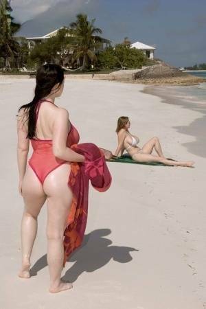 Plump female Christy Mark and her big boobed friend have lesbian sex on beach on leakfanatic.com