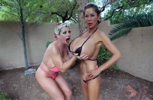 Big titted older women Claudia Marie and Minka kiss outdoors in skimpy bikinis on leakfanatic.com