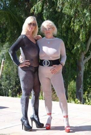 Mature blonde Melody and her lesbian lover bare their boobs on a building site on leakfanatic.com