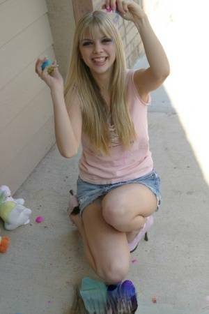 Sweet blonde teen Jana Jordan flashes upskirt panties while eating chocolate - Jordan on leakfanatic.com