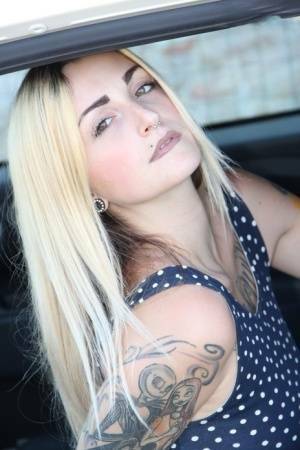 Tattooed girl Medusa Blonde shows her bare feet and ass while in a car on leakfanatic.com