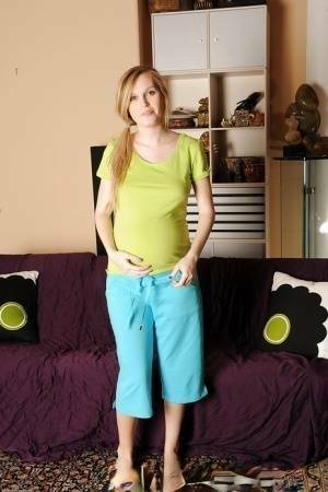 Smiley pregnant amateur with puffy nipples and hairy gash getting naked on leakfanatic.com