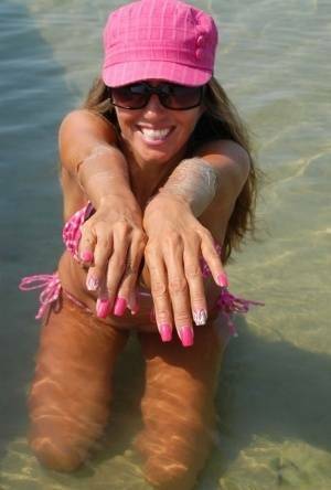 Amateur model Lori Anderson shows her hairy arms while wearing a bikini on leakfanatic.com