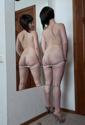 White teen with a full bush admires herself in mirror while disrobing on leakfanatic.com