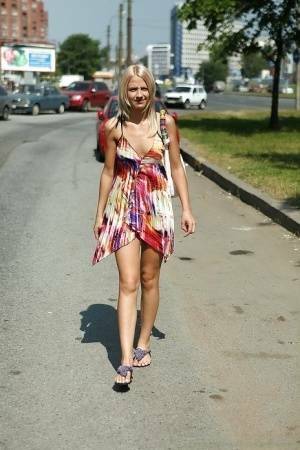 Charming teen blonde posing solo in a lovesome dress outdoor on leakfanatic.com