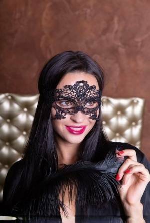 Sexy brunette Leyla Lee removes a mask and robes to pose nude with a feather on leakfanatic.com