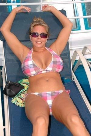 Hugely busty Amber Lynn Bach doffs her bikini to spread her legs wide nude on leakfanatic.com