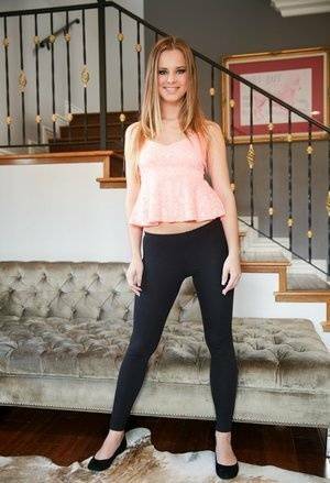 Slim white girl Jillian Janson wears a nice smile while removing spandex pants on leakfanatic.com