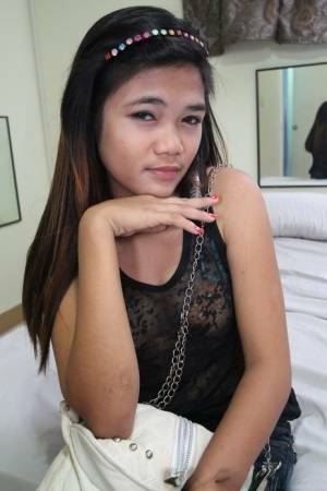 Young Filipina girl with a saucy look stands naked after undressing on leakfanatic.com