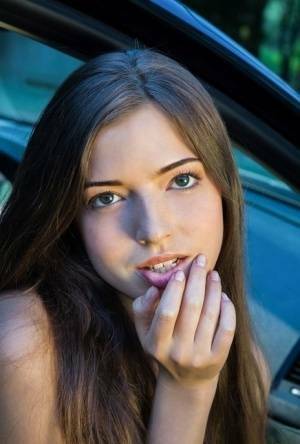 Beautiful teen girl models in the nude on passenger seat of car with door open on leakfanatic.com