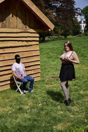 Natural redhead masturbates on a lawn before teasing a masked man on leakfanatic.com