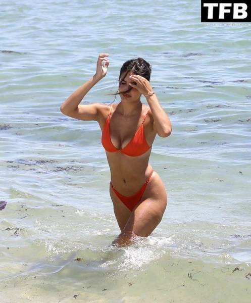 Tao Wickrath Stuns in Small Orange Bikini on the Beach in Miami on leakfanatic.com